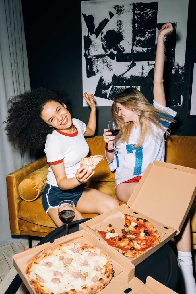 Two girls with pizza